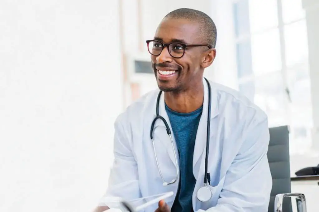 Smiling doctor speaking with patient