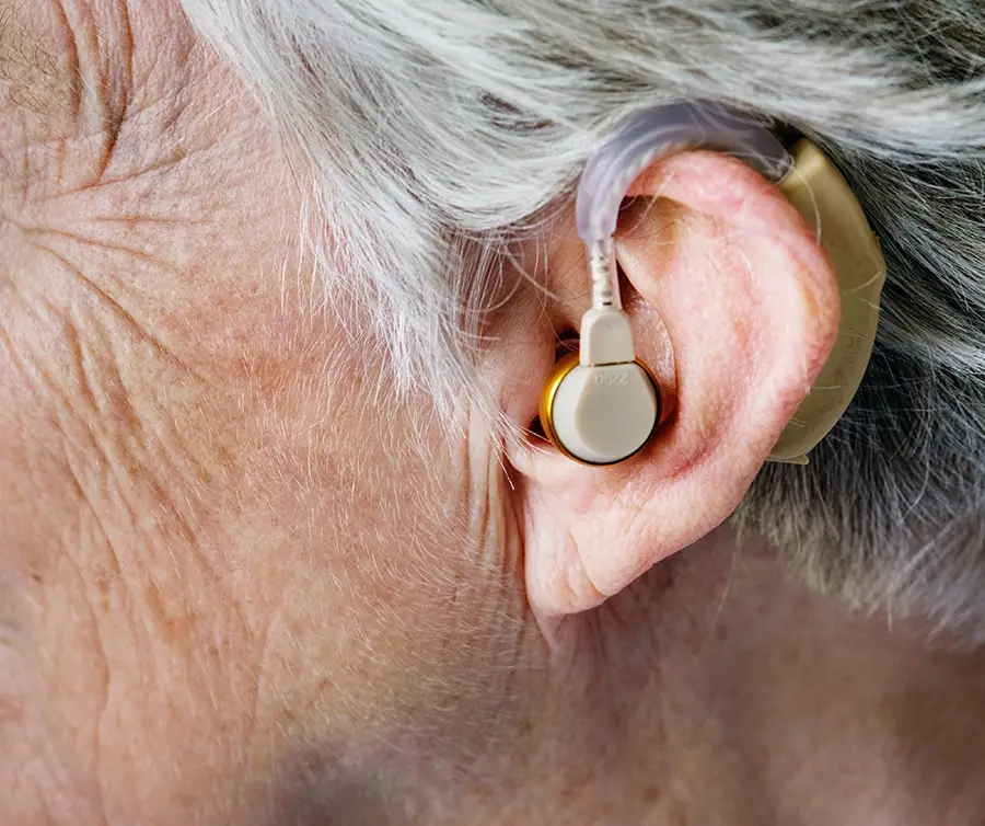 Senior with hearing aid